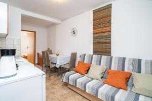 a living room with a couch and a table at Apartments Villa Cerjak in Slano