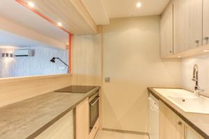 a kitchen with a sink and a counter top at Le Clos Du Lac - location de chambres in Veyrier-du-Lac