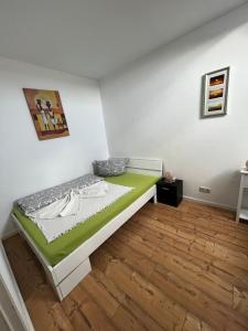 Schlafzimmer mit einem Bett mit grüner Matratze in der Unterkunft Ferienwohnung Coburger Land, ländlich gut gelegen in Meeder