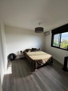 a bedroom with a bed and a large window at Nouveauté Sunset appart vue exceptionelle in Saint-Denis