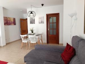a living room with a couch and a table at Centro Histórico de Málaga in Málaga