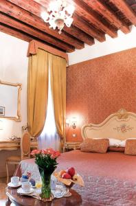 a bedroom with a bed and a table with fruit on it at Apostoli Palace in Venice