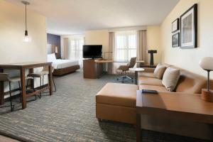 a hotel room with a couch and a bed at Residence Inn Houston Westchase On Westheimer in Houston