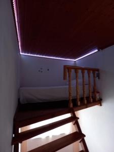 a staircase leading to a room with a ceiling with lights at Casa da Ribeira em Rabal in Rabal
