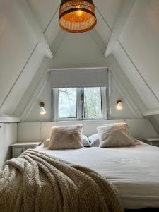 a bedroom with a large bed in a attic at Chalet 190 La Belle Durbuy in Durbuy