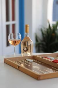 Psamathe Aegina Apartments في ايجينا تاون: زجاجة من النبيذ وكأس على الطاولة