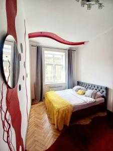 a bedroom with a bed and a tv in it at Ratusha Apartments in Lviv