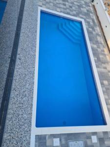 a blue pool on the side of a building at Apartment Dado in Trogir