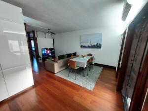 a living room with a table and a couch at Troia Setubal Praia in Troia