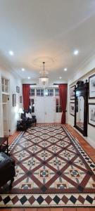 a living room with a large rug on the floor at Kerriston Manor House in Mooiriver +11 photos