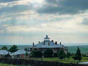 a large house with a tower on top of it at Kerriston Manor House in Mooiriver