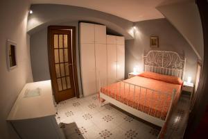 een slaapkamer met een bed met een oranje dekbed bij Robs House in Riomaggiore