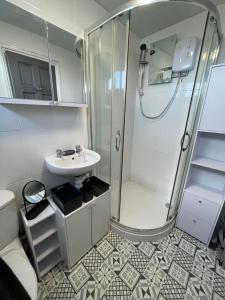 a bathroom with a shower and a sink at 88, Belle Aire, Hemsby - Two bed chalet, sleeps 5, bed linen and towels included - pet friendly in Great Yarmouth