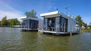 a building on the water on a river at ARKA 1 domki na wodzie w Mielnie, rower wodny, bezpłatny WIFI, Parking in Mielno