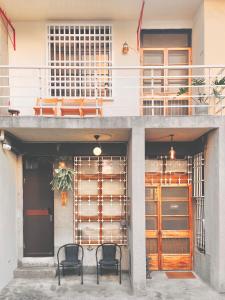 a group of chairs sitting outside of a building at 青青小院 Qing Yard in Tainan