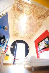 a room with a ceiling with a painting on it at KISS ME ROME Luxury Rooms in Rome