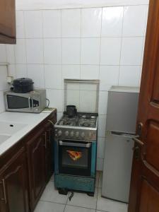 a kitchen with an oven with a pizza in it at Mousse Diop in Dakar