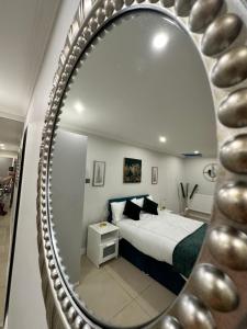 a bedroom with a bed and a mirror at Luxury Studio Apartment in Harrow on the Hill