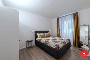 a bedroom with a bed and a large window at Wild Zagara Garden View in La Spezia