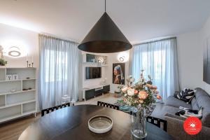 a living room with a table and a couch at Wild Zagara Garden View in La Spezia