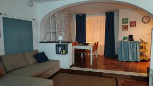 a living room with a couch and a table at La Casa di Milly in Sori
