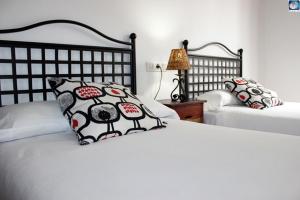 En eller flere senge i et værelse på Hotel Arco de Mazarelos