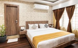 a bedroom with a large bed in a room at HOTEL BRAHMAPUTRA MADHUKALYA in Guwahati