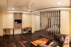 a living room with a couch and a table at HOTEL BRAHMAPUTRA MADHUKALYA in Guwahati