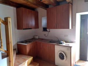 a kitchen with a sink and a washing machine at Casa Lovaco (Borau) in Borau +7 photos