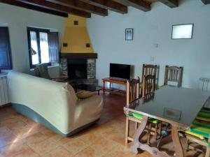 a living room with a couch and a table at Casa Lovaco (Borau) in Borau