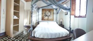 a bedroom with a bed with a canopy at Villa Bruna in Poggibonsi