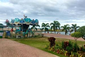 a merry go round in a park next to a body of water at Danao LC Bayview in Idanao