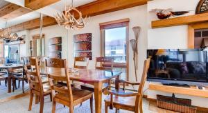 a dining room with a table and chairs and a tv at 2 Br 2Ba Spacious Condo With A Fireplace Condo in Crested Butte