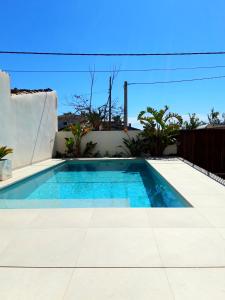 a swimming pool in the backyard of a house at CASA PISCINA DOCTOR FLEMING 51 in Llubí