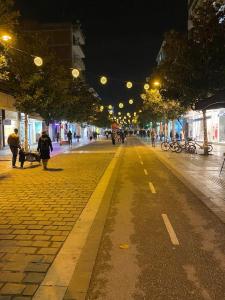 a city street at night with people walking on the street at Dream home Serres romantic living in Serres