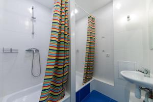 a bathroom with a shower, sink, and toilet at Hostel Champion in Yekaterinburg