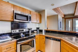 a kitchen with a stove and a microwave at 2 Br With Open Floor Plan & Updated Kitchen Condo in Crested Butte