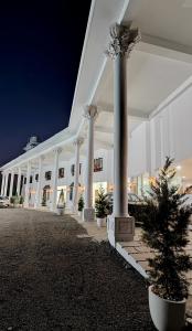 a building with columns and a christmas tree in a courtyard at HOTEL WHITE HOUSE, Munnar in Munnar