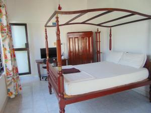 a bedroom with a canopy bed and a piano at Horton Studios in Colombo