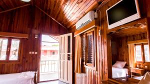 a bedroom with a bed and a tv on a wooden wall at Toll Garden in Side