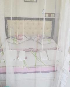 a bed in a room with a curtain at Akay Hotel in Patara