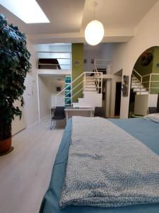 a room with a bed and a staircase at Sweet Apartments and Rooms in Niš