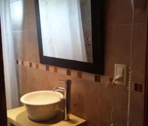 a bathroom with a sink and a mirror on the wall at paraíso la Caleta in Mar de Cobo +13 photos