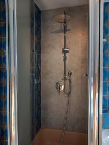 a bathroom with a shower with a tub at Ferienhaus Carolin in Heidenheim an der Brenz
