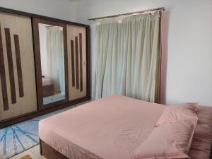 a bedroom with a bed and a large mirror at Amwaj North coast chalet in 1st floor families only in El Alamein