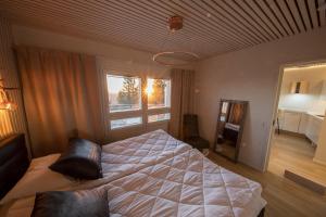 sypialnia z dużym łóżkiem i oknem w obiekcie Tunturihuoneisto LAAKEUS w mieście Syöte