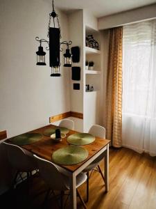 a dining room table with chairs and a dining room at Gold Box Apartament in Gdańsk