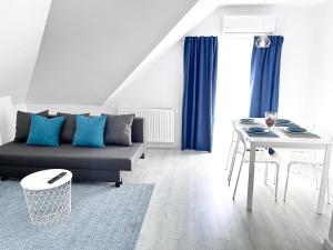 a living room with a couch and a table at Mira new appartment in Otopeni near airport in Otopeni