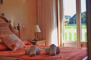 a bedroom with a bed with a large window at La Mies de Vallegon - 1801 in Isla