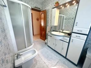 a bathroom with a sink and a toilet and a mirror at La Mies de Vallegon - 1801 in Isla +25 photos